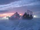 car and people in blizzard